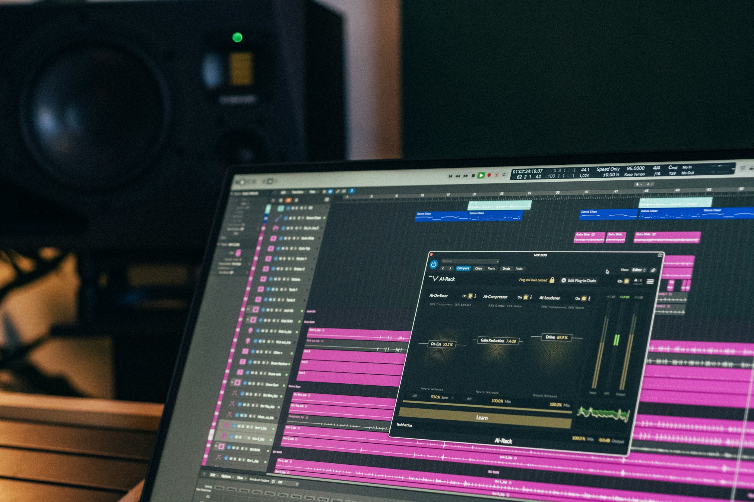 A computer screen displays a digital audio workstation with multiple audio tracks and an plugin interface on a music production software.