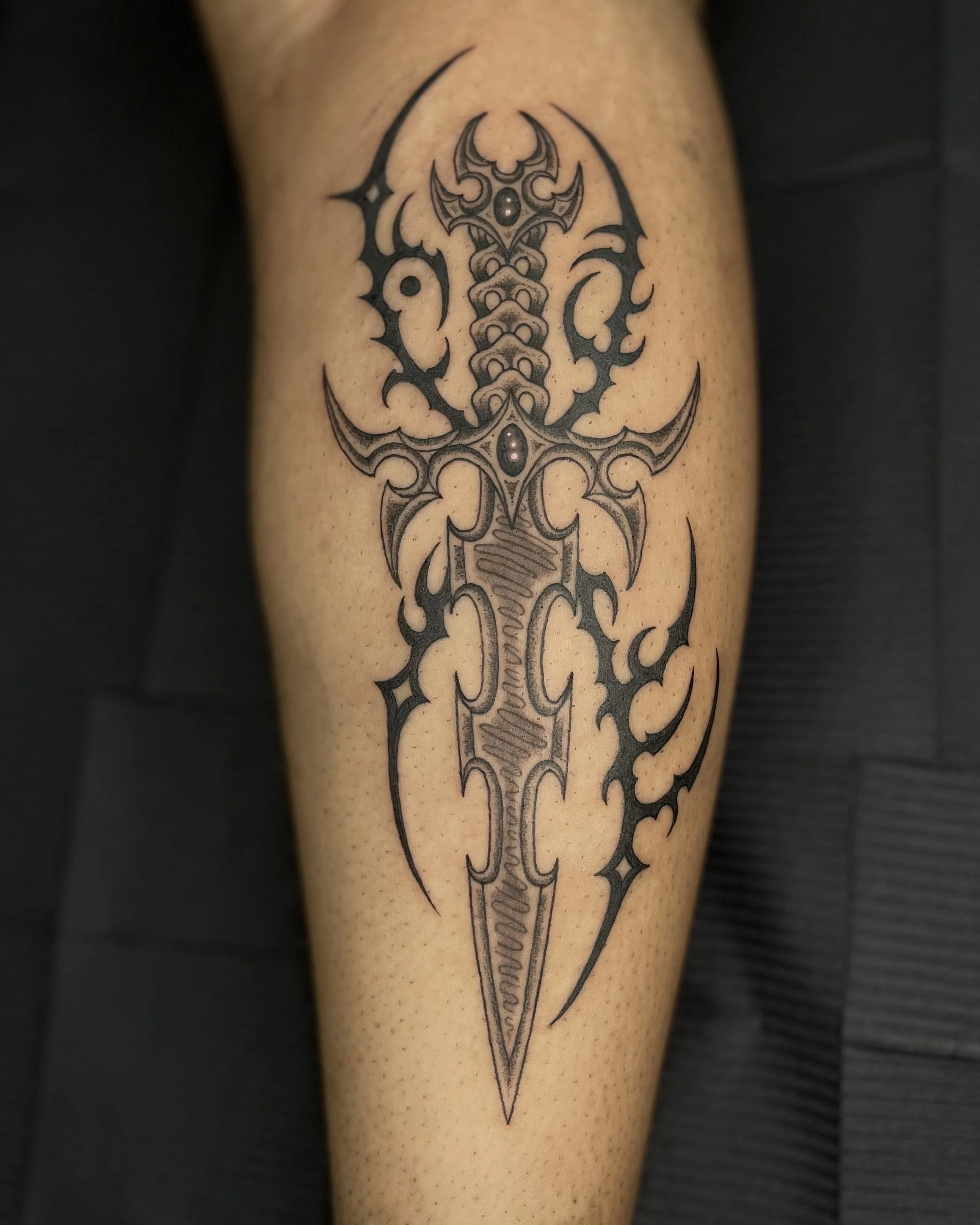 dagger and neo tribal tattoo