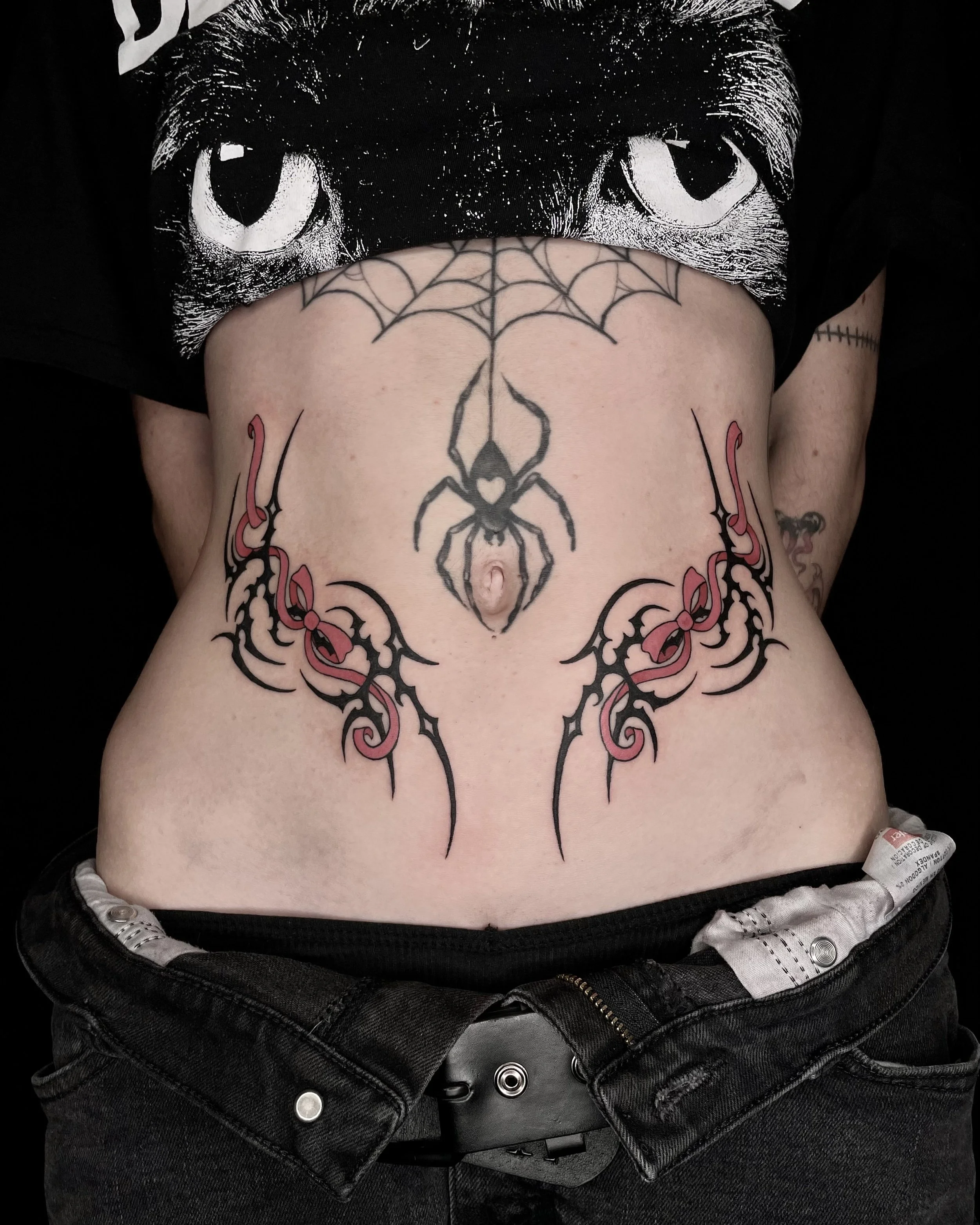 symetrical tribal and  bow tattoos