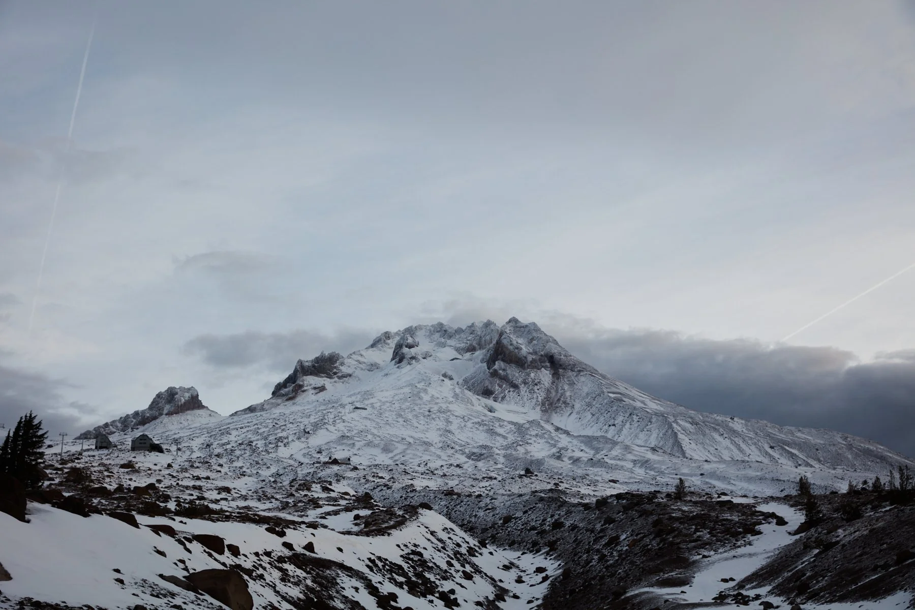 Snow-covered mountain with a cloudy sky.