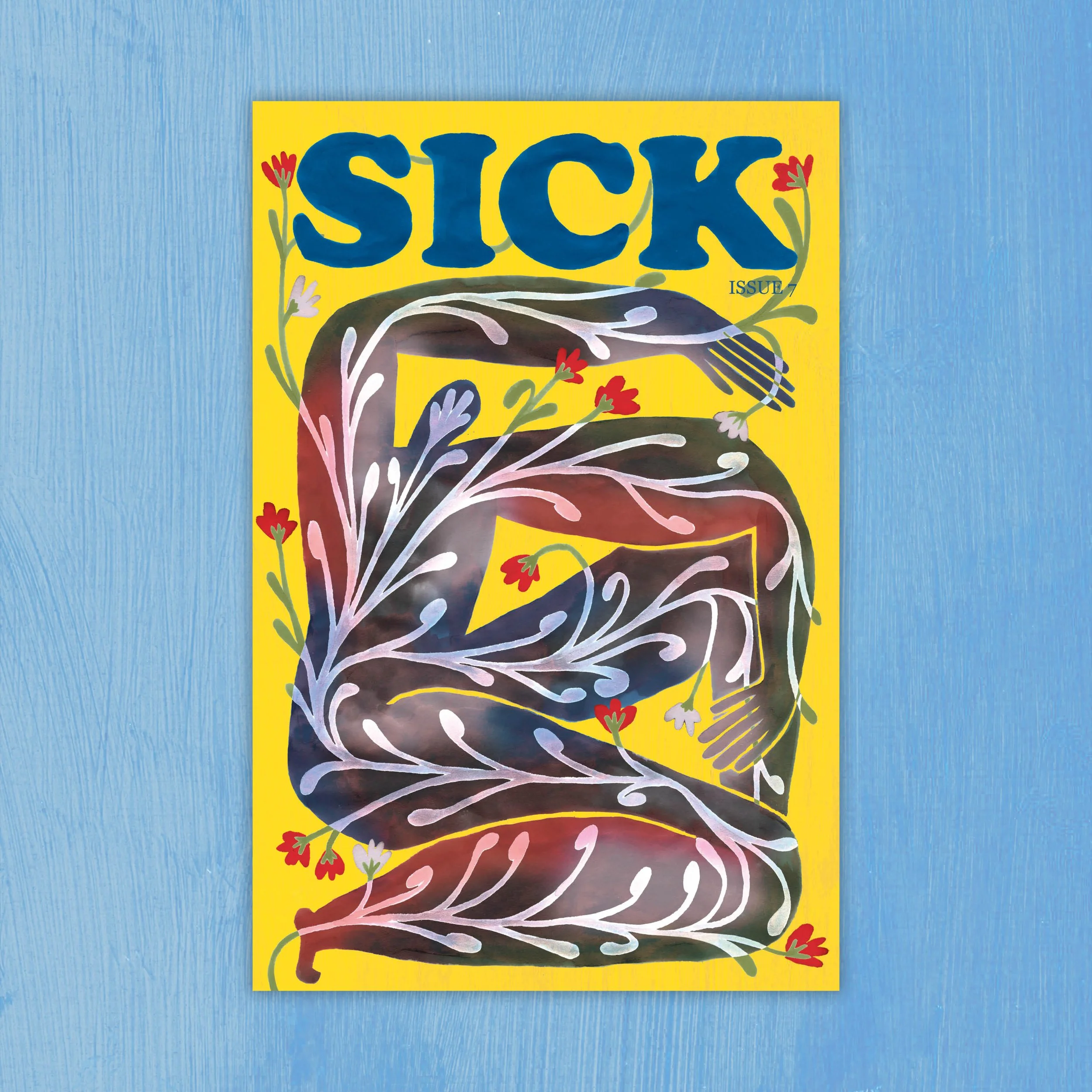 SICK magazine issue 7 cover, decorated with white and red floral patterns, against a yellow background, on a blue textured surface.
