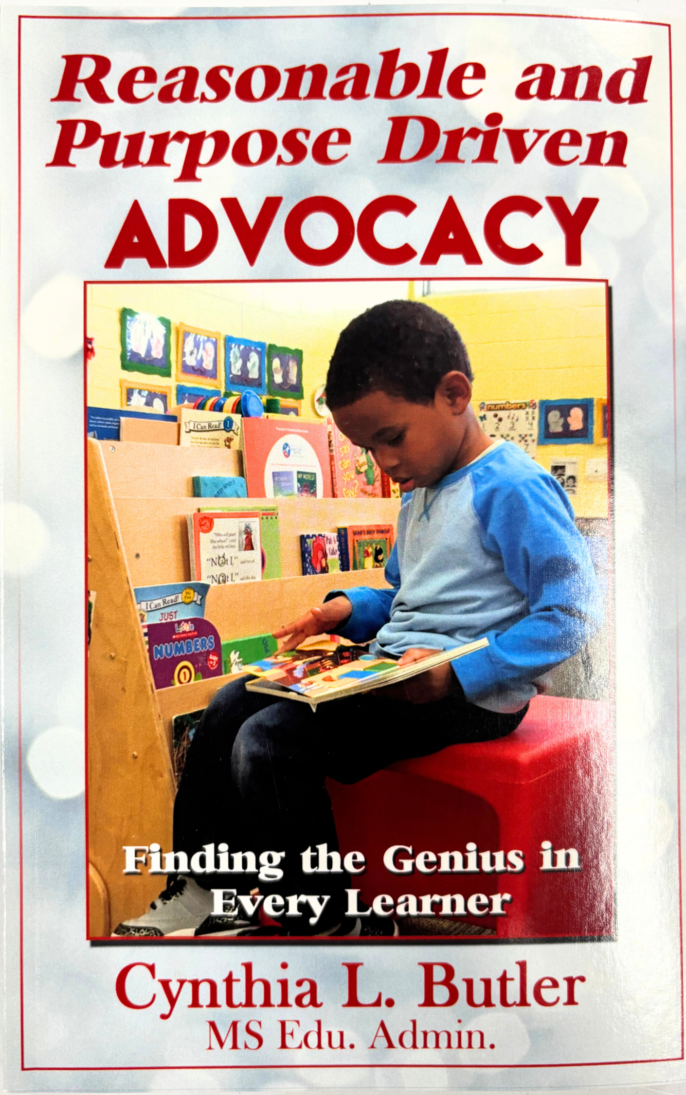 Book cover titled 'Reasonable and Purpose Driven Advocacy' with a photo of a young boy reading a book in a classroom, and the subtitle 'Finding the Genius in Every Learner' by Cynthia L. Butler, MS Edu. Admin.