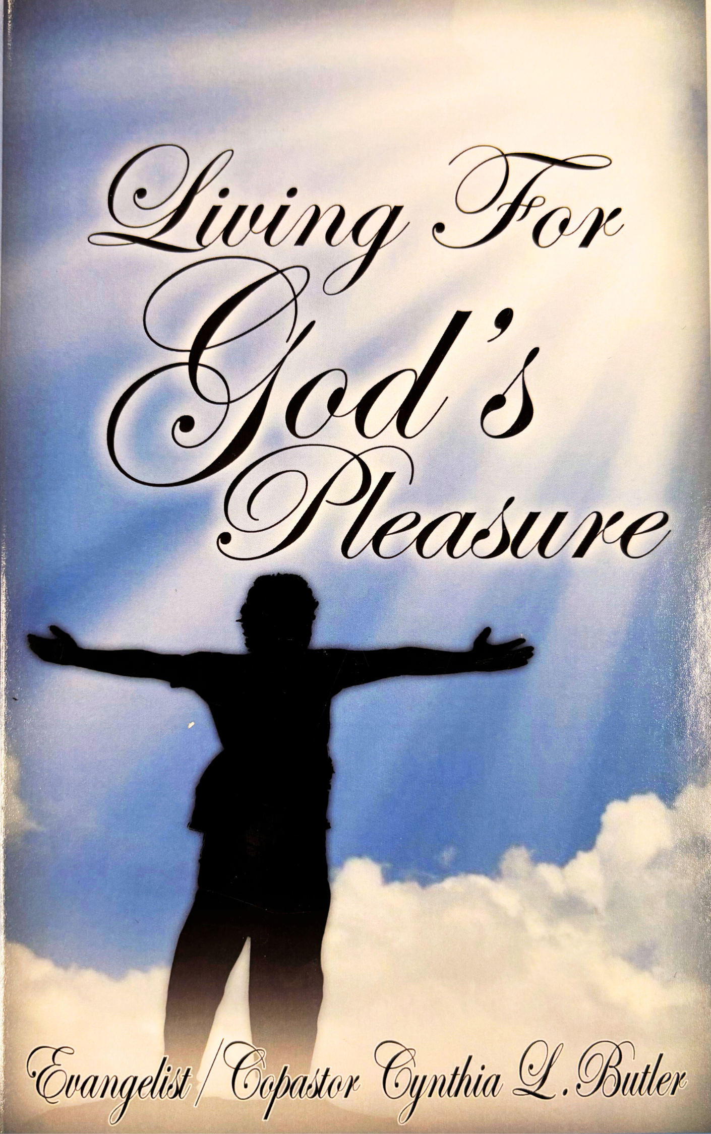 Book cover titled "Living for God’s Pleasure" with a silhouette of a person with arms outstretched against a sky with clouds.