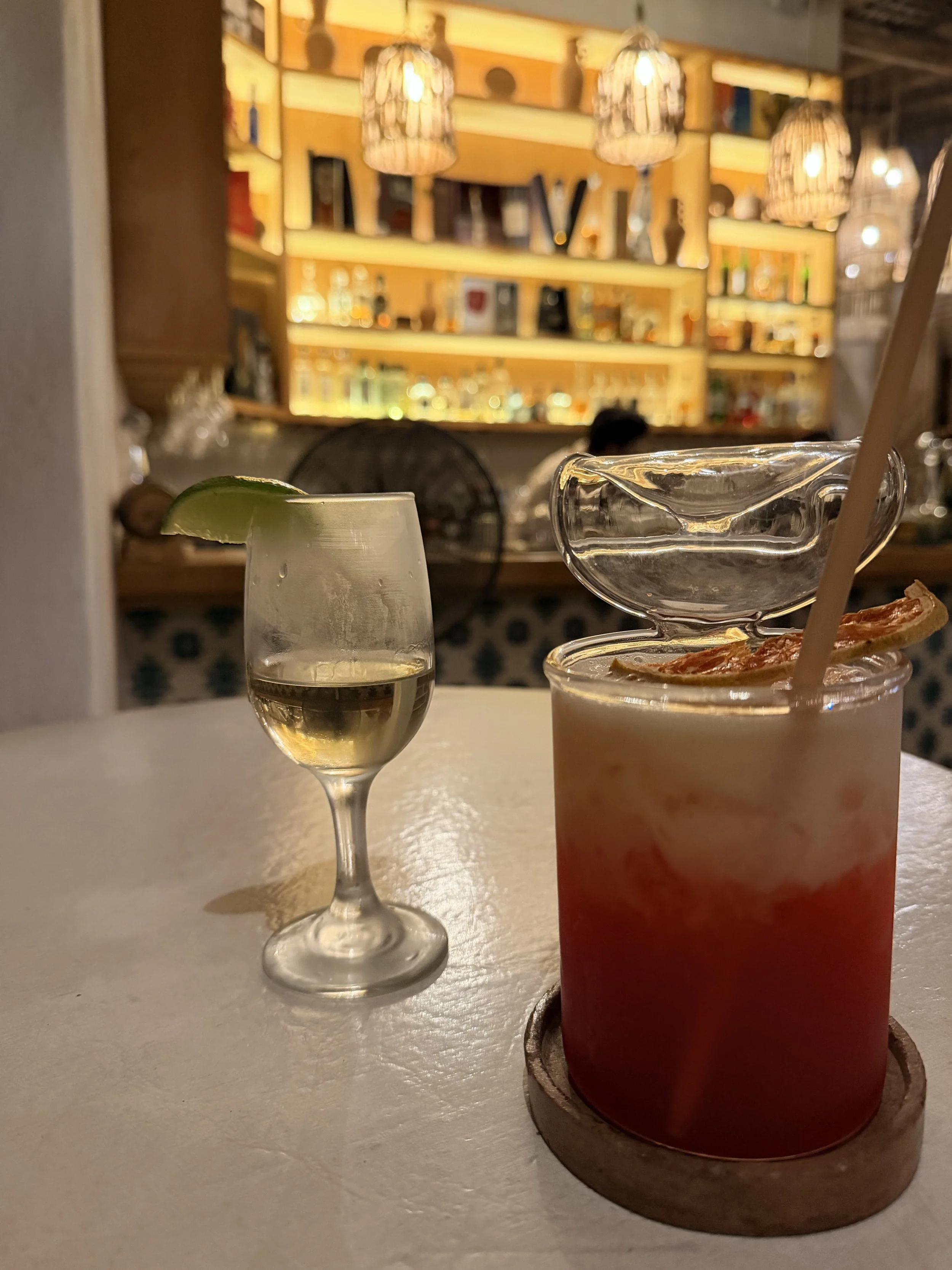 Elegantly presented cocktails and wine glasses at an event venue bar, styled for an Obsidian Opal Events celebration