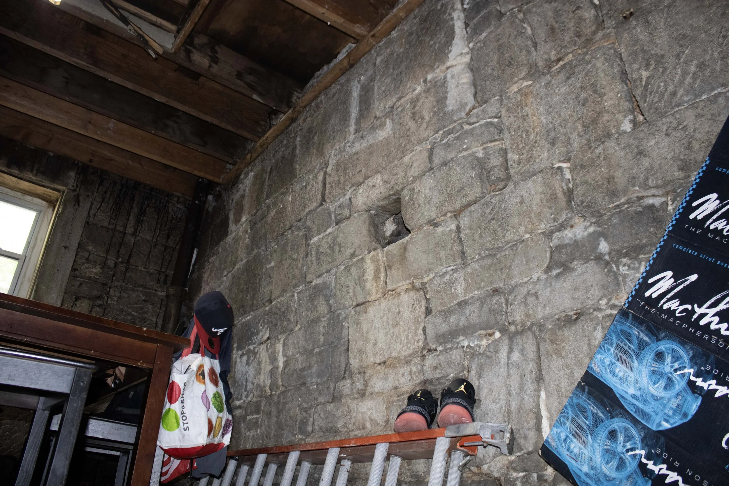 Second floor of arch in the autobody shop, wall seen bulging.