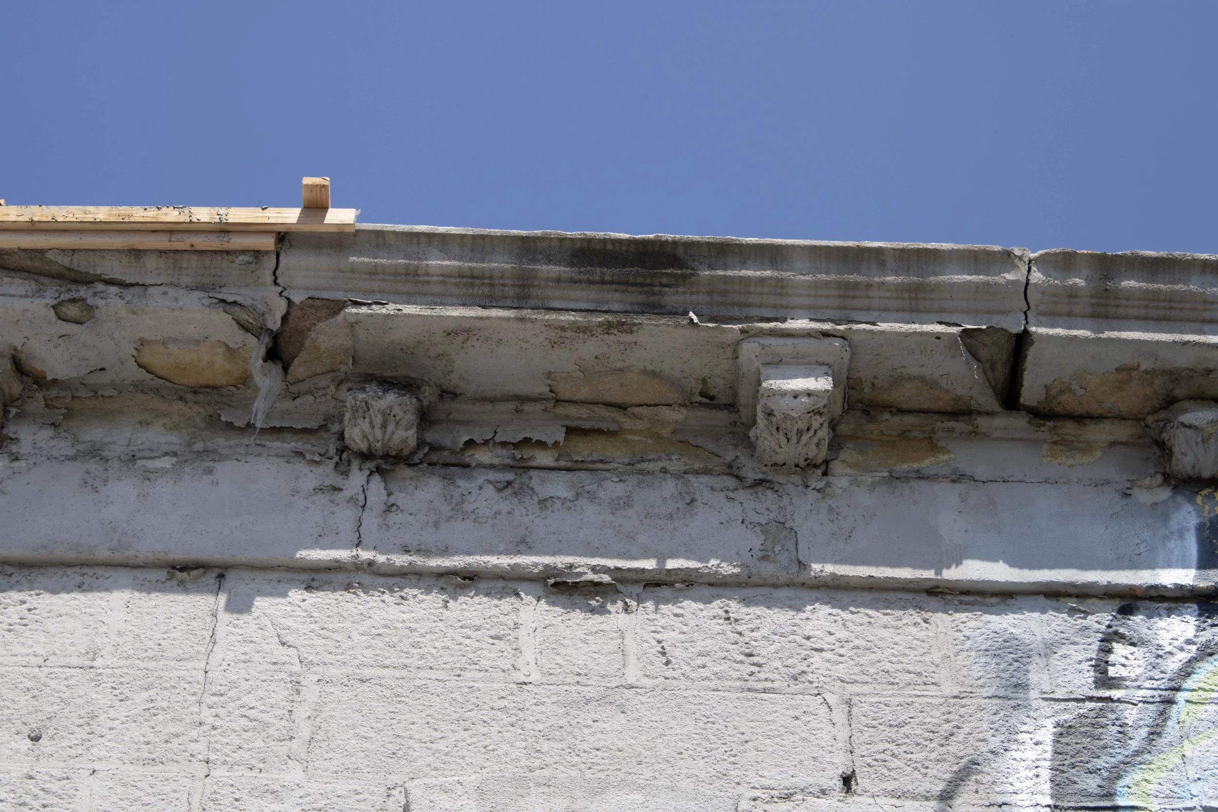 Ad hoc wood repair to the cornice.
