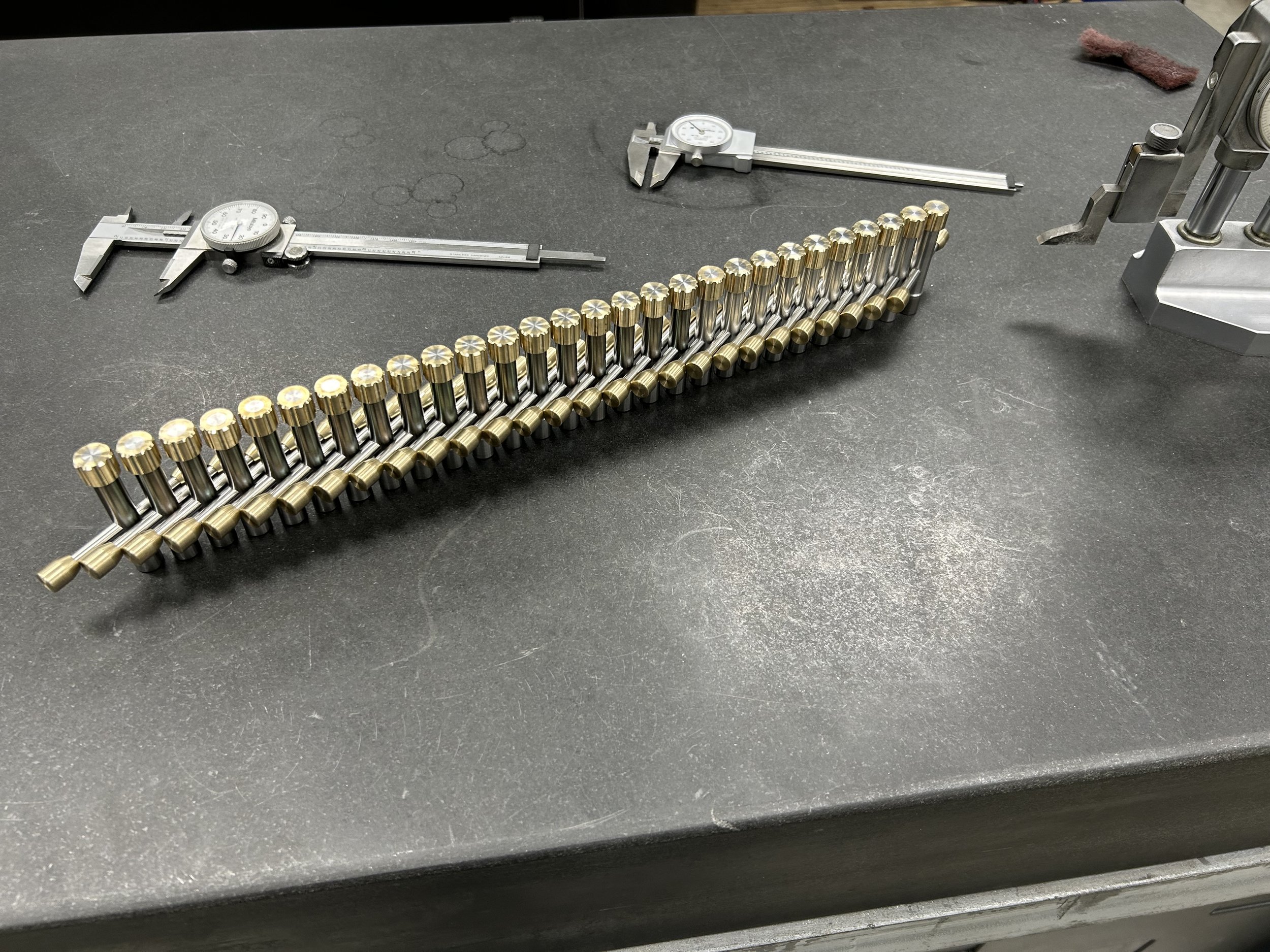 Custom High Quality Drum Keys being quality control tested on a surface plate with calipers and height gage.