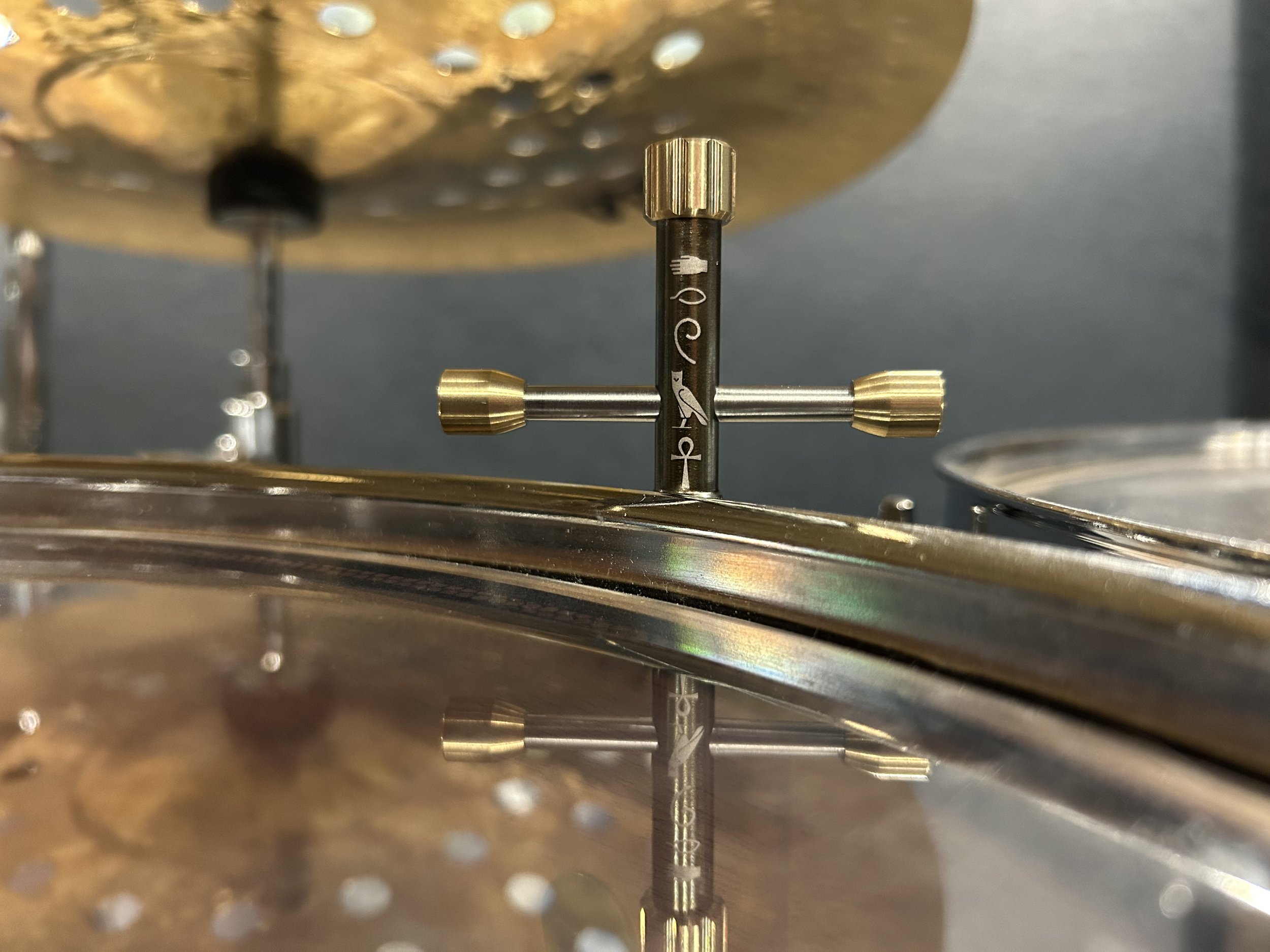 Close-up view of a DG drum key adjusting a component of a Drum. Anubis custom drum key.