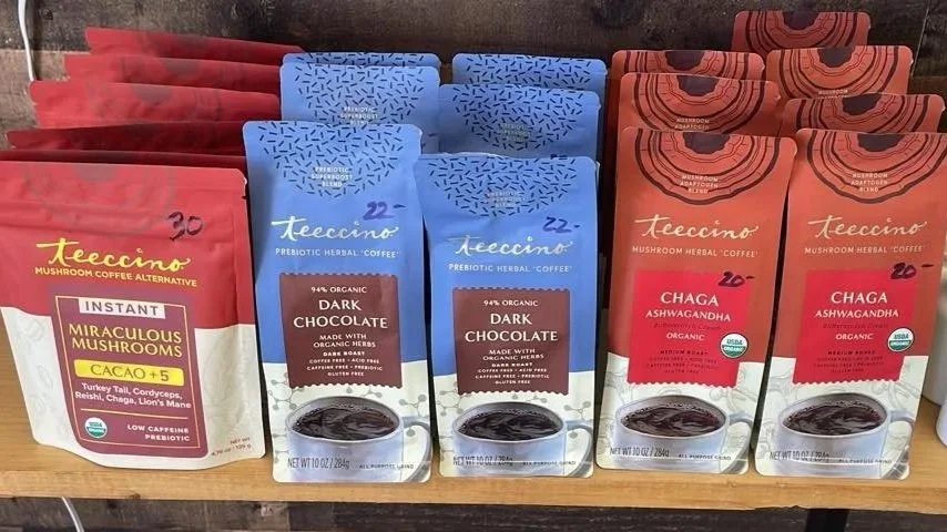Assorted packages of Teecino mushroom herbal coffee in red, blue, and orange packaging.