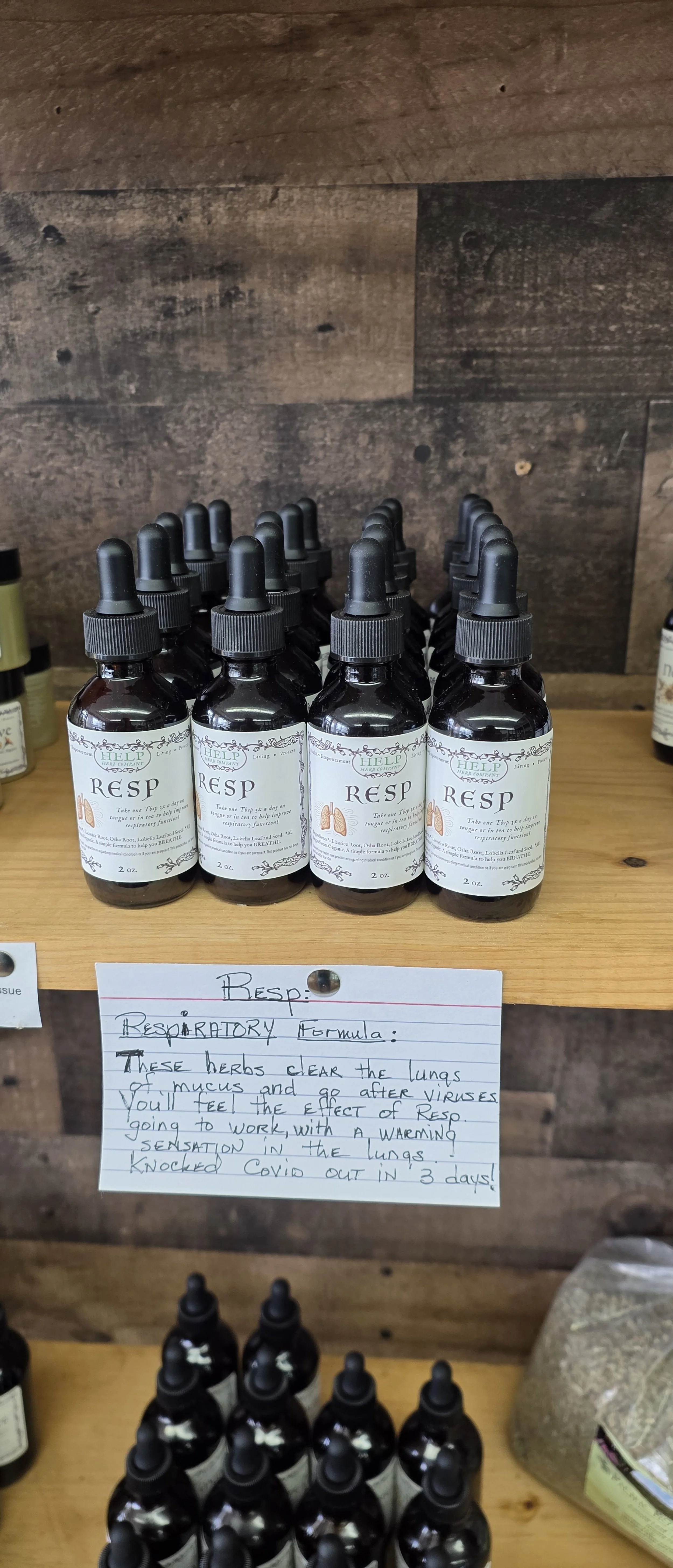 Bottle of herbal respiratory remedy labeled RESPI, with handwritten description explaining it clears lungs of mucus and viruses, and helps recover from COVID in three days.