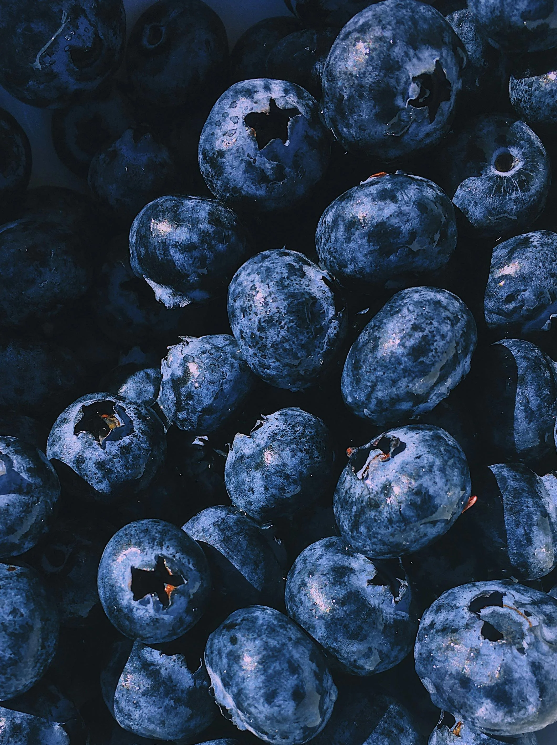 A close-up of fresh blueberries, showing their blue color and textured surface.