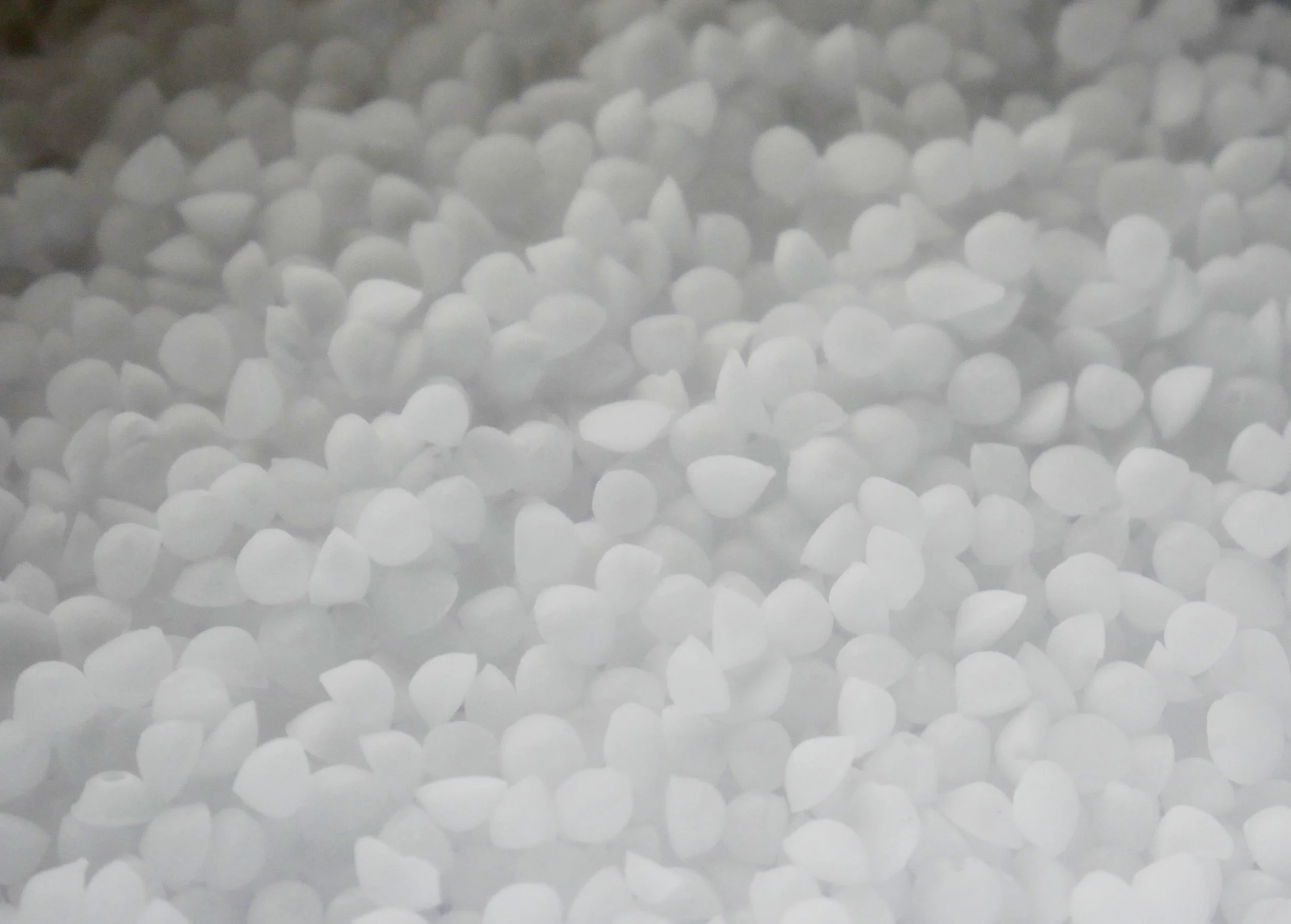 Granulated white powder on wooden table. 