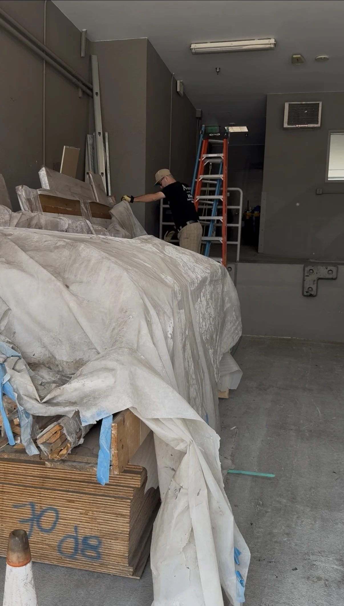 A to Z Hauling crew member clearing wood debris and trash from a high-rise loading dock in Beverly Hills, CA