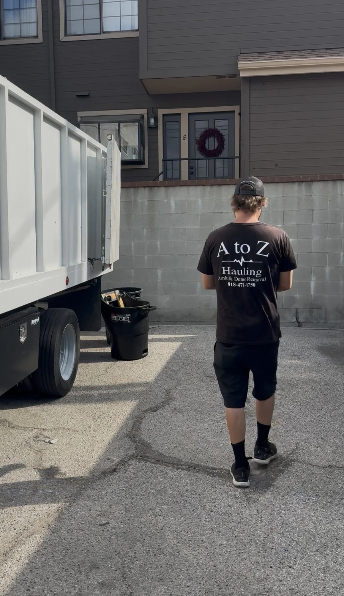 A to Z Hauling Junk Removal crew member enter an 15 unit apartment complex clearing other an apartment in burank, Ca for a property management company