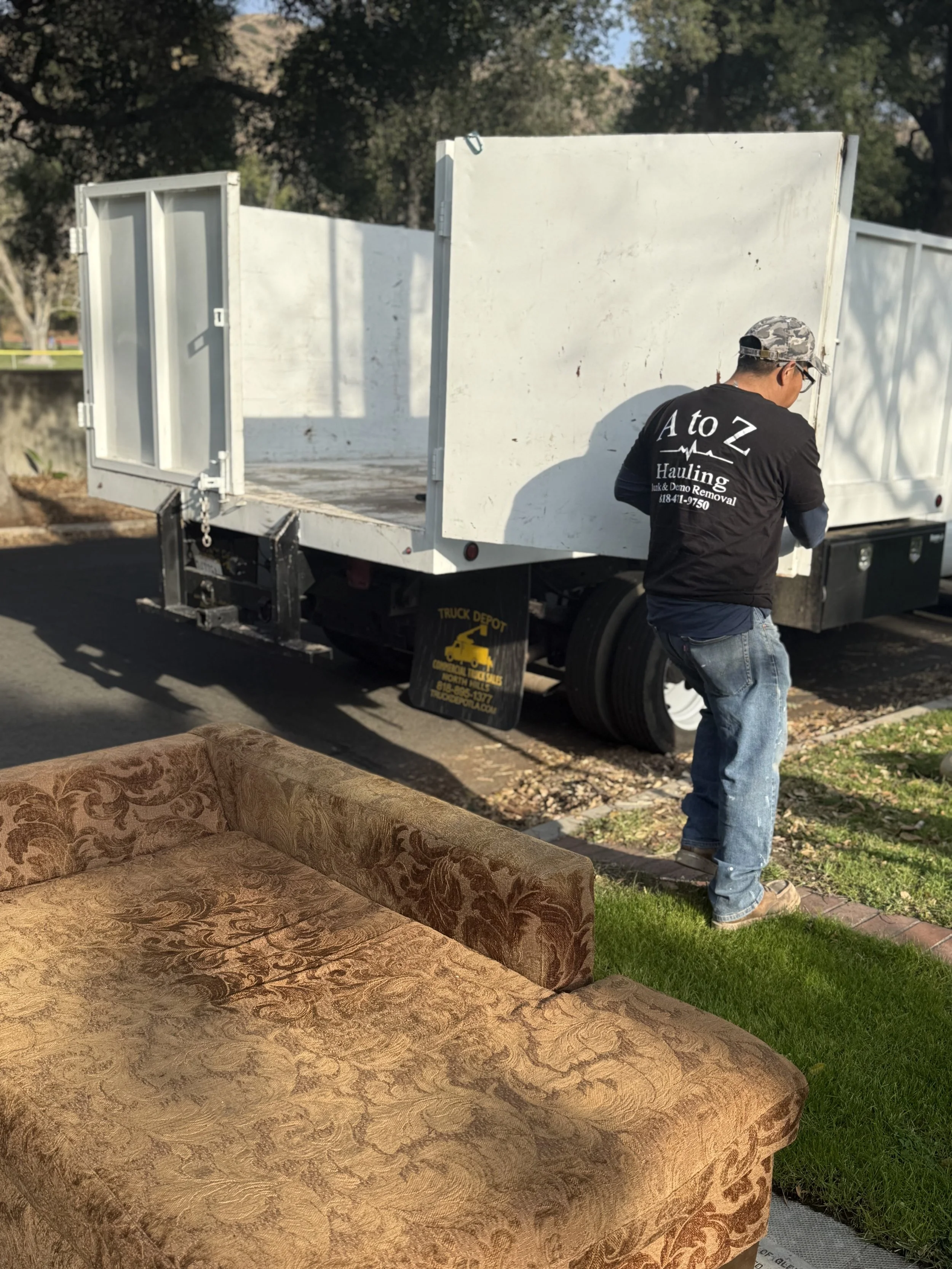 a to z hauling junk removal crew member opening truck doors to begin a general junk removal pickup in Glendale ca