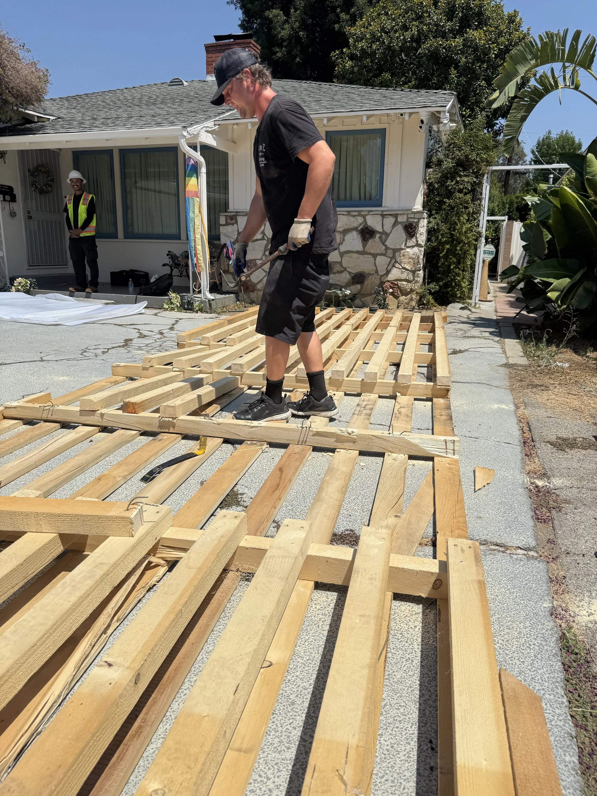 A to Z Hauling crew member removing oversized pallet that was blocking clients driveway