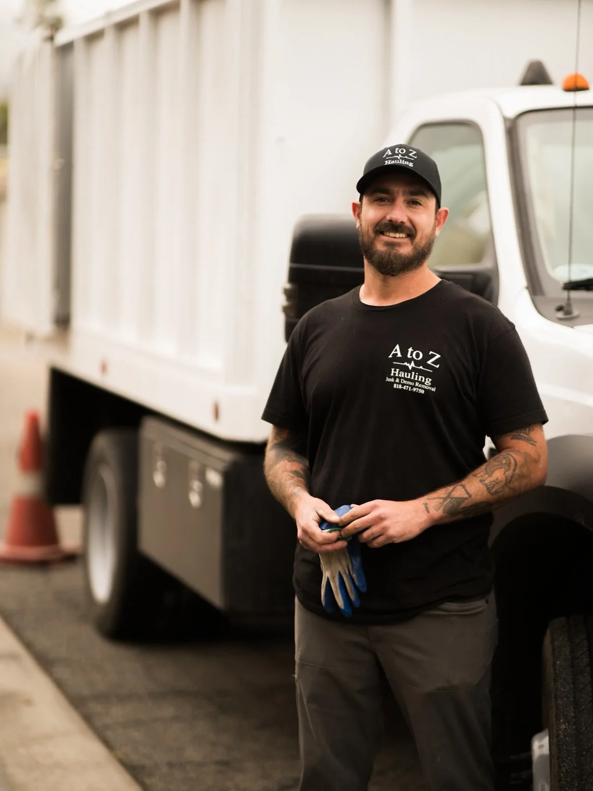 Owner Zach standing next to the dump truck