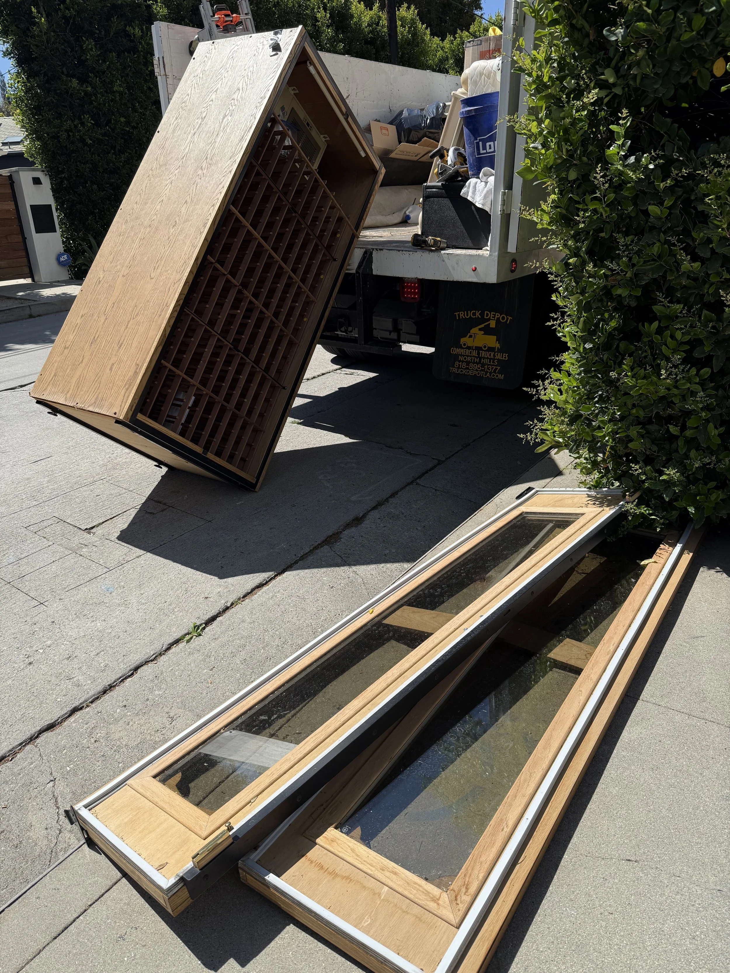 Loading a Large wine cooler into the A to Z Hauling Dump truck