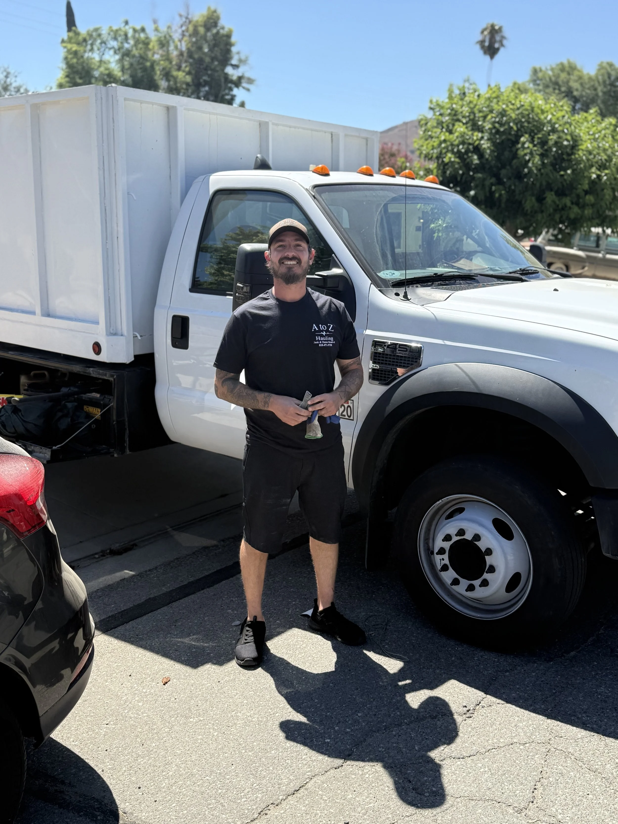 A to Z Hauling junk removal owner standing by the truck after a successful property cleanout in Chatsworth ca