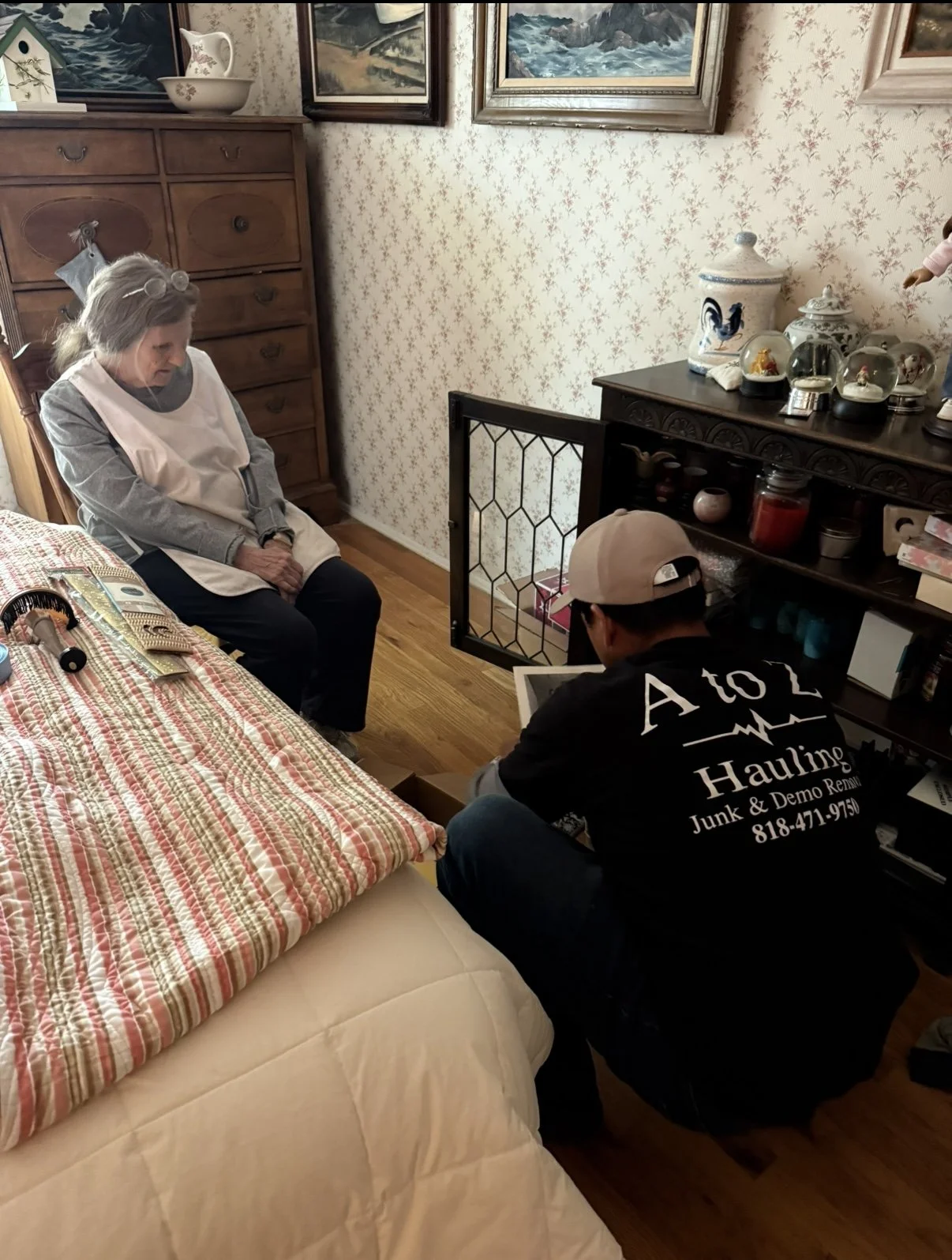 A to Z Hauling team member helping a client go through belongings at her own pace during a cleanout