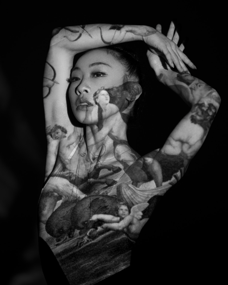 Black and white photo of a woman with tattoos, with an overlay of a classical painting of mythological figures and cherubs.