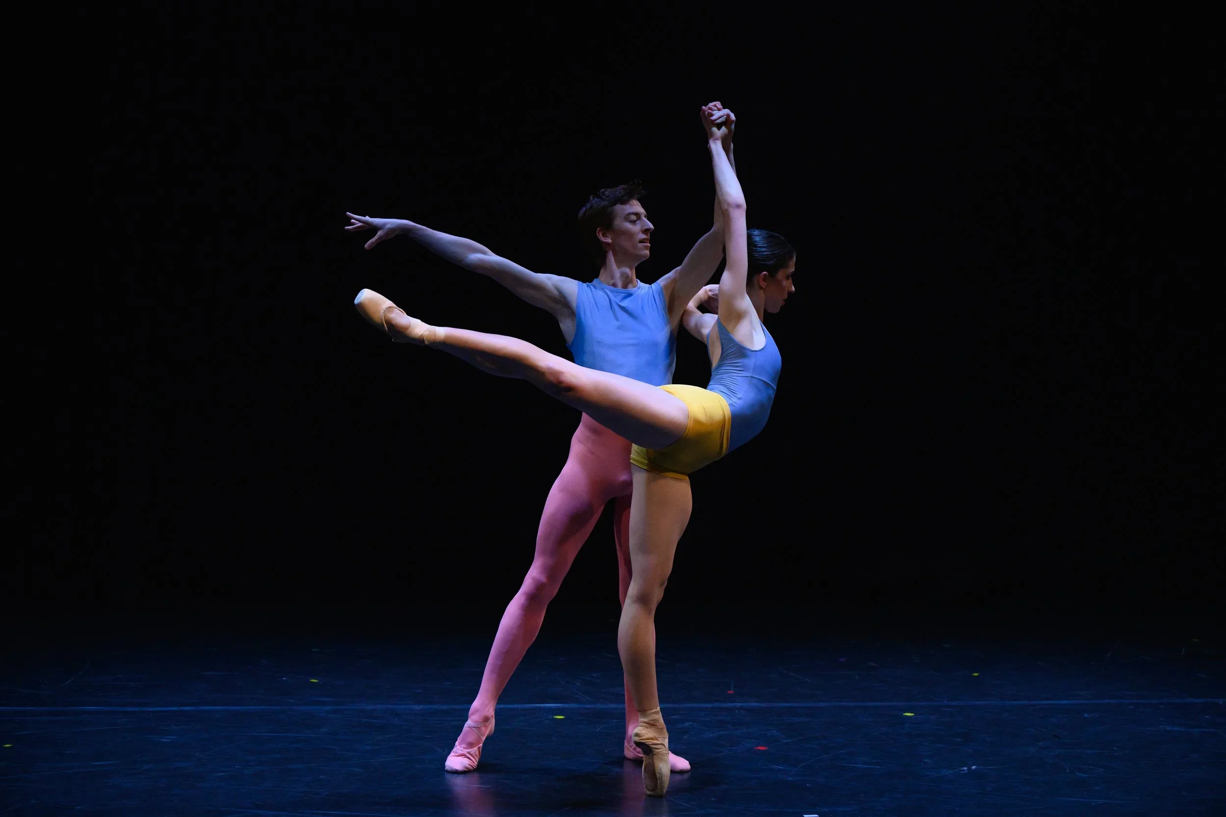Image of two dancers together in colourful costumes