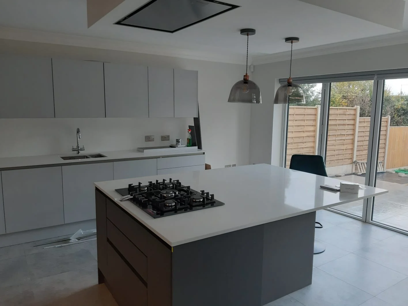 Open-plan kitchen renovation with new layout, lighting and wood flooring in London.