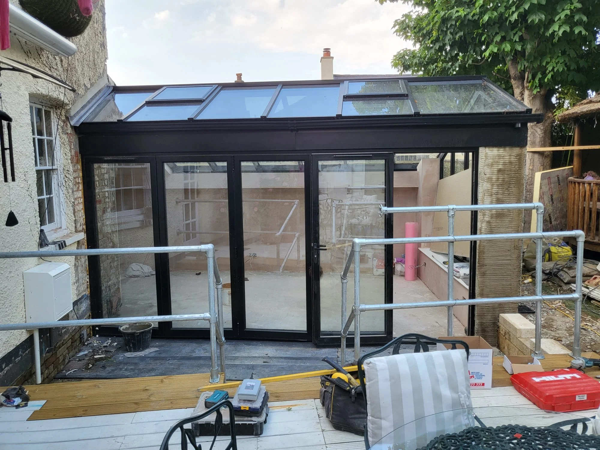 Conservatory extension with expansive glass roof and sliding door for a seamless indoor-outdoor feel