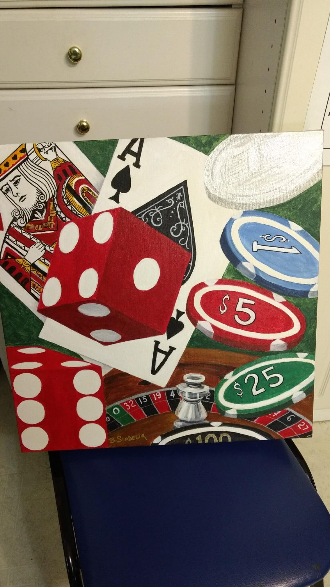 Painting of casino game elements including a playing card, a red die, poker chips with values of $5, $25, and $100, and a roulette wheel, signed by B. Sinder.