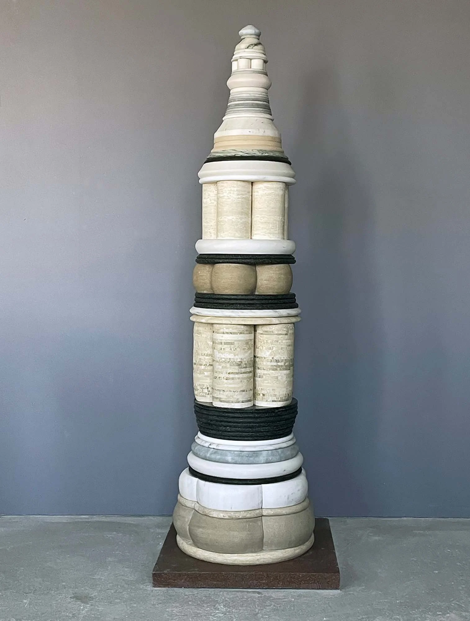 Stories We Tell, 2026, Marble, limestone, travertine and granite, 86 x 24 x 24 inches