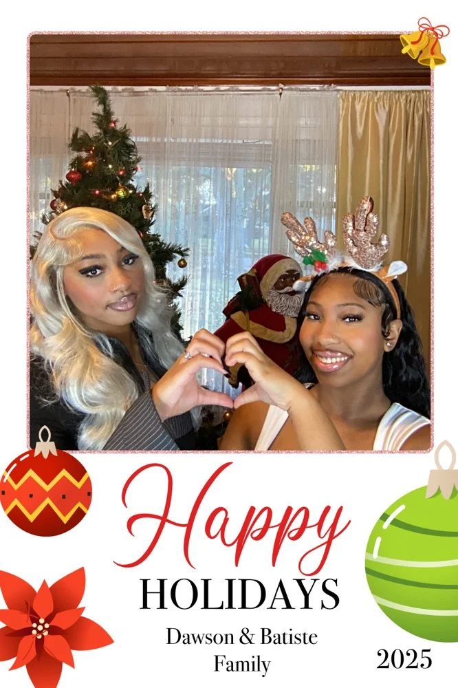 Kee Kreates Photo Booth. Two women with styled hair and makeup, wearing festive attire, making a heart shape with their hands in front of a decorated Christmas tree and Santa Claus figure, with holiday greeting text and ornaments at the bottom.