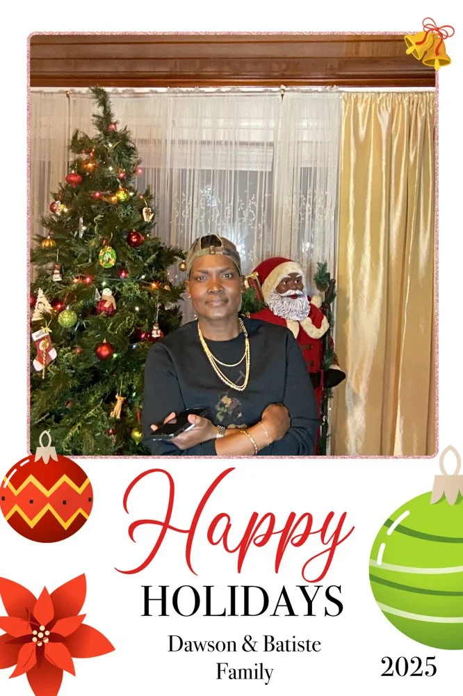 Kee Kreates Photo Booth. A woman in black clothing and gold jewelry standing in front of a decorated Christmas tree and a Santa Claus figure, with holiday-themed border design.