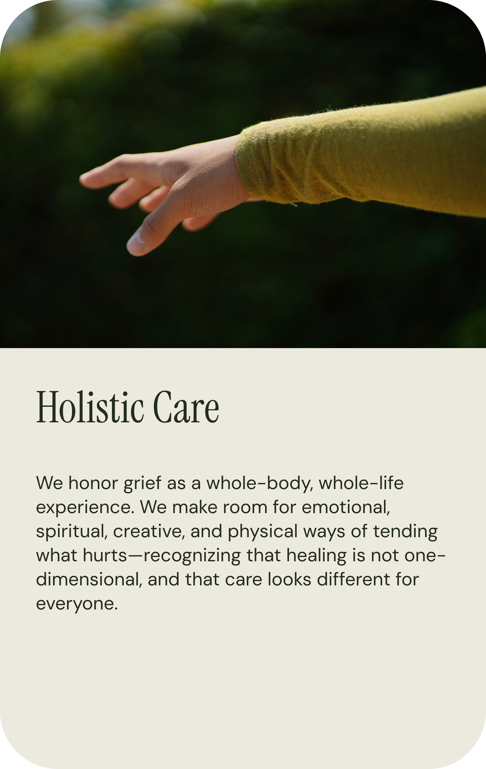 A close-up of a person's hand reaching out in an outdoor natural setting. The person is wearing a green long-sleeve shirt, and the background is blurred with green foliage.