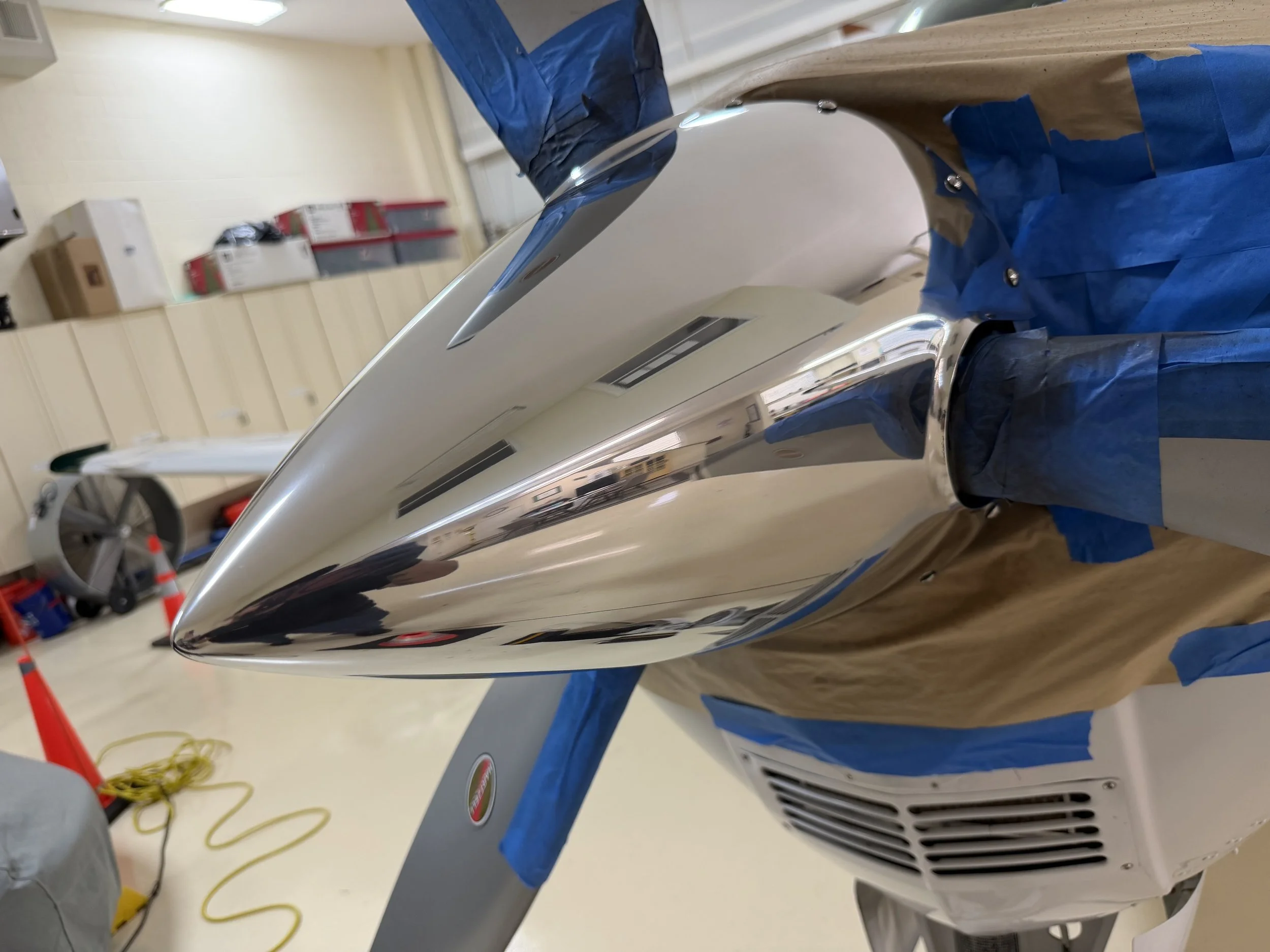 Mirror-finish brightwork restoration on a Beechcraft Bonanza B36TC propeller spinner by JetReady Detailing, showcasing premium aircraft metal polishing and aluminum restoration in Tampa, Florida.