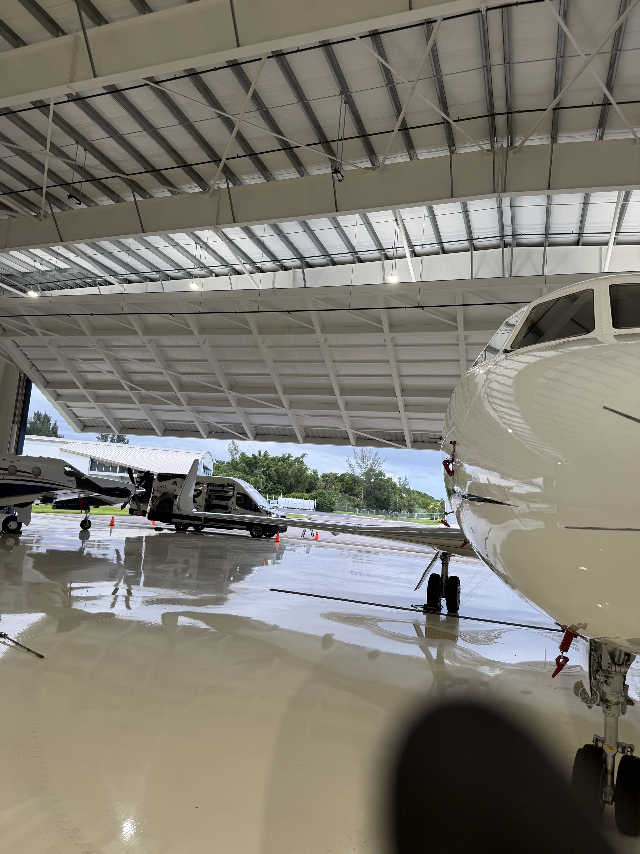 Professional private aircraft detailing and maintenance inside a Florida hangar.