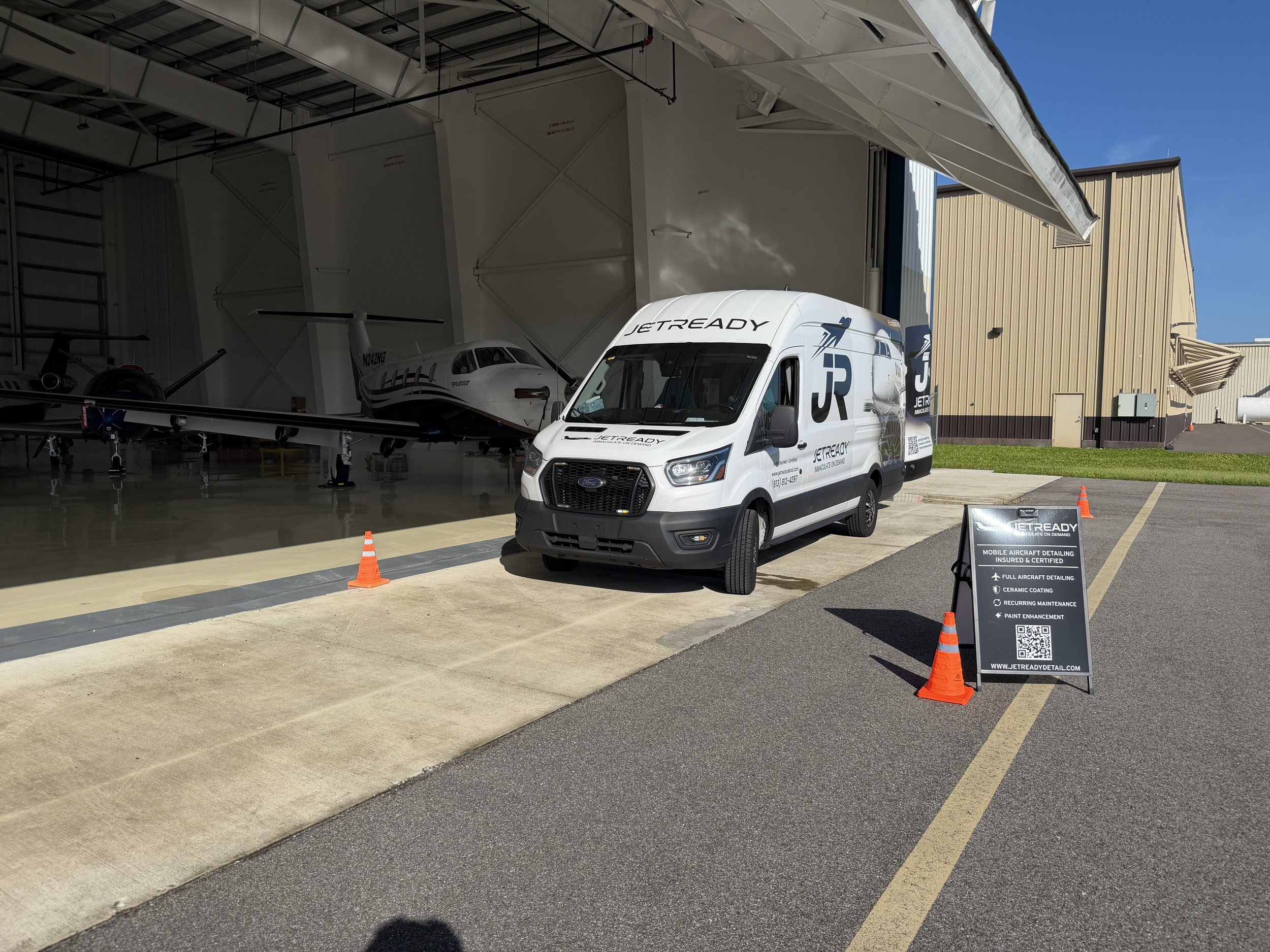 JetReady mobile aircraft detailing van servicing an aircraft at a Florida airport.