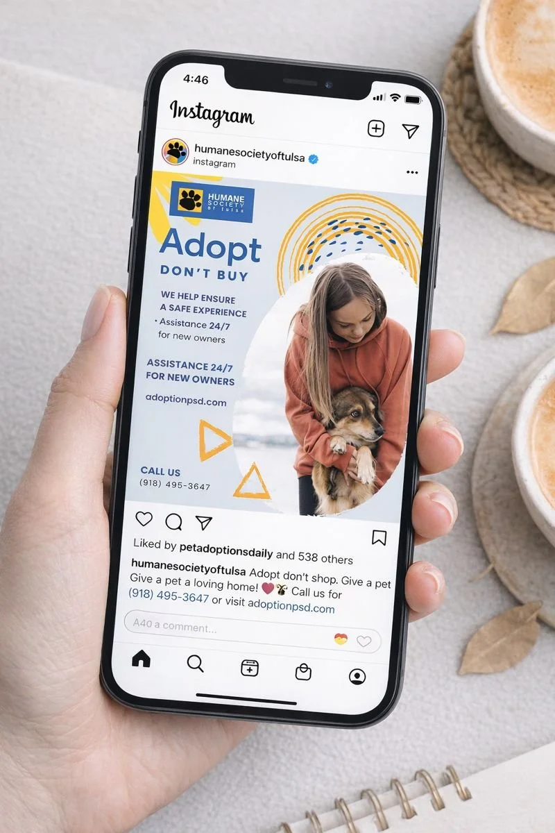 A mobile phone displaying an Instagram post from Humane Society of Tennessee Valley about pet adoption, showing a girl hugging a dog with text promoting pet adoption and contact information.