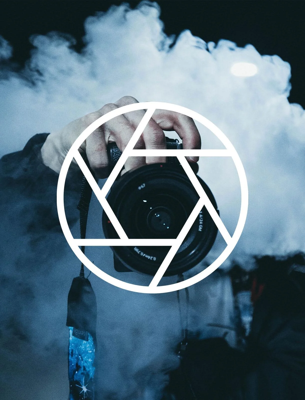 A person taking a photo with a camera in front of clouds and the moon at night, with a geometric white overlay on the image.