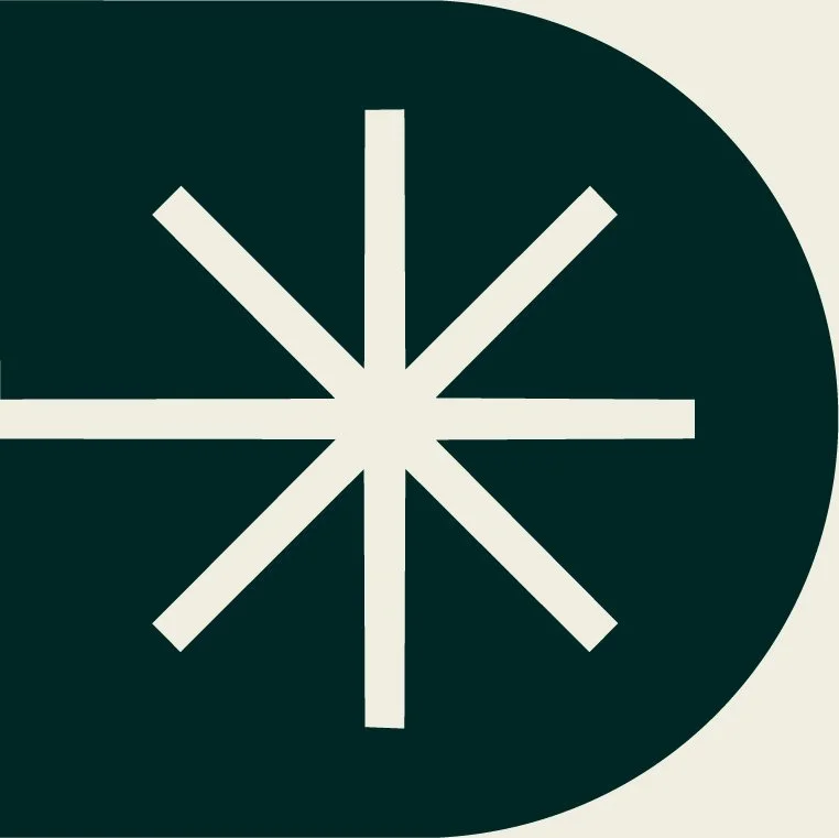 A dark green circle with white lines radiating from the center, forming a starburst pattern, on a light background.