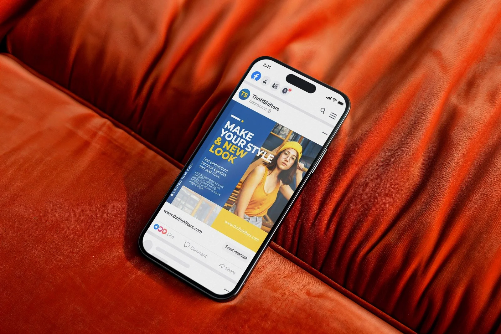 Smartphone showing an advertisement for ThriftShifters, with a woman in a yellow hat and shirt on the screen, resting on a red velvet couch.