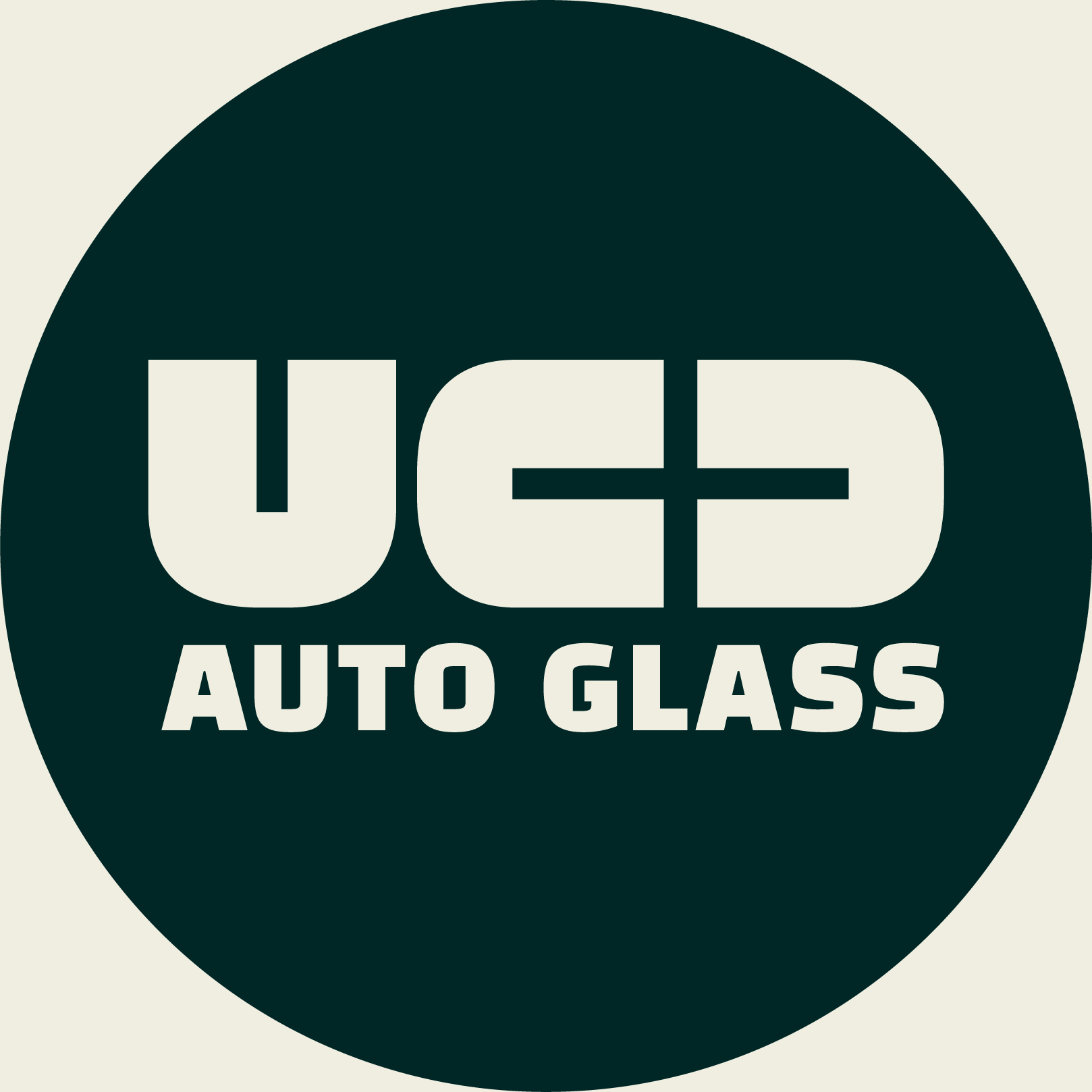 A logo with a dark green circle background and white text that reads 'UCD AUTO GLASS'