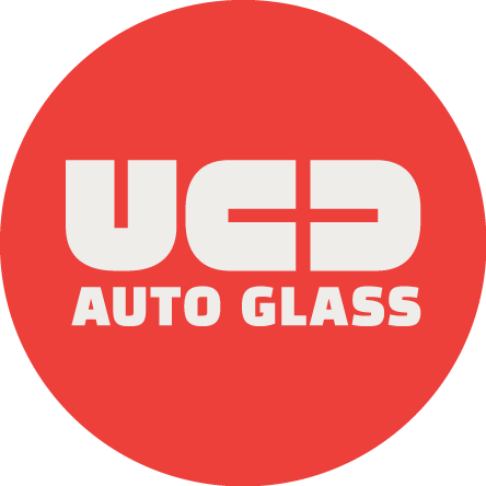 UCD Auto Glass logo with red background and white text.