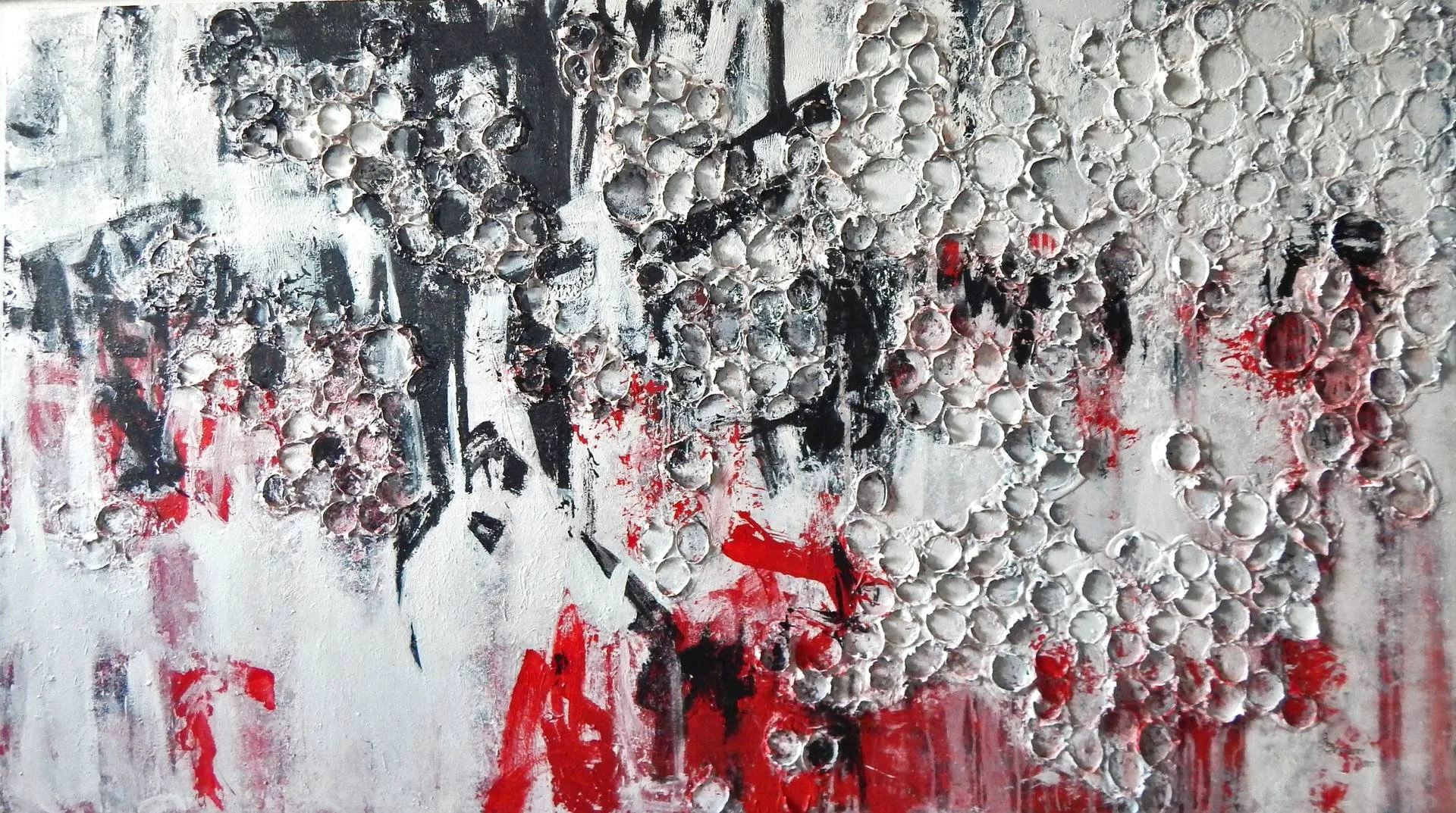 Abstract painting with textured white bubble-like elements, black scribbles, and splashes of red paint.