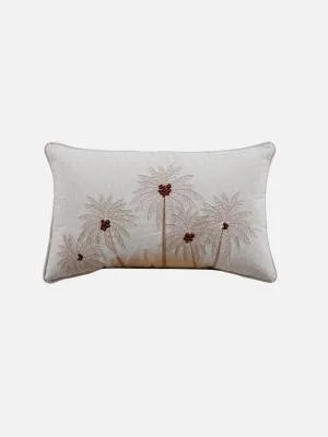 Decorative pillow with palm trees embroidered in beige and brown on a white background.