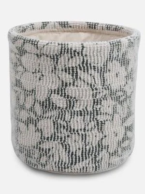 A round fabric planter with a black and white snakeskin pattern.