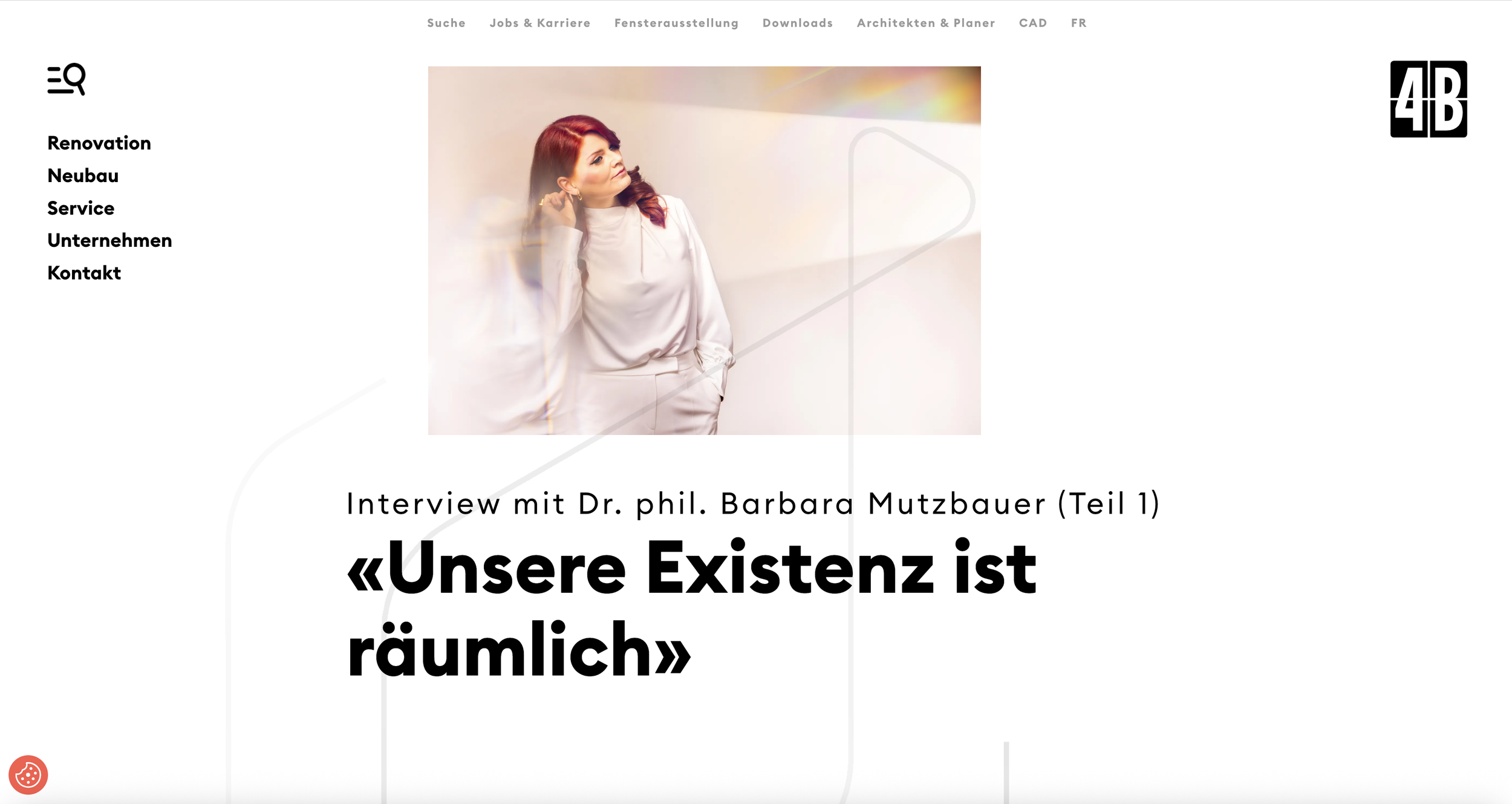 A woman with red hair, wearing a light-colored blazer, standing with her hand on her chin, looking thoughtfully into the distance. The background is softly lit with warm tones.