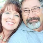 A smiling woman and man taking a selfie together