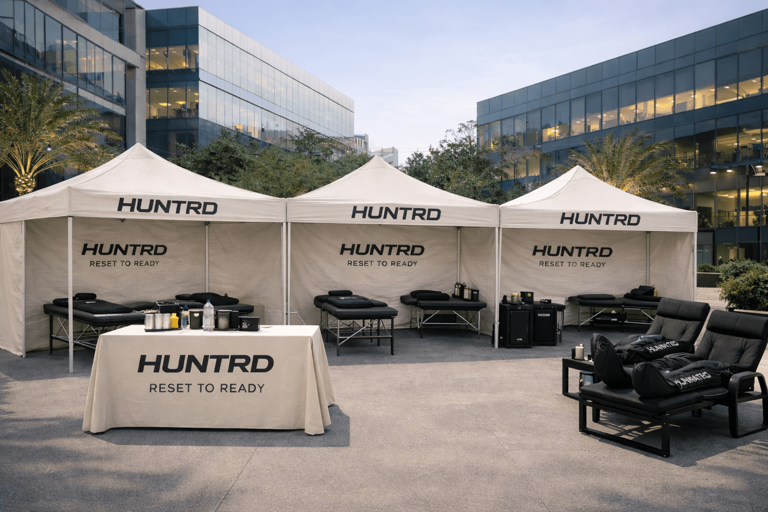 HUNTRD branded recovery lounge tent setup at a corporate office