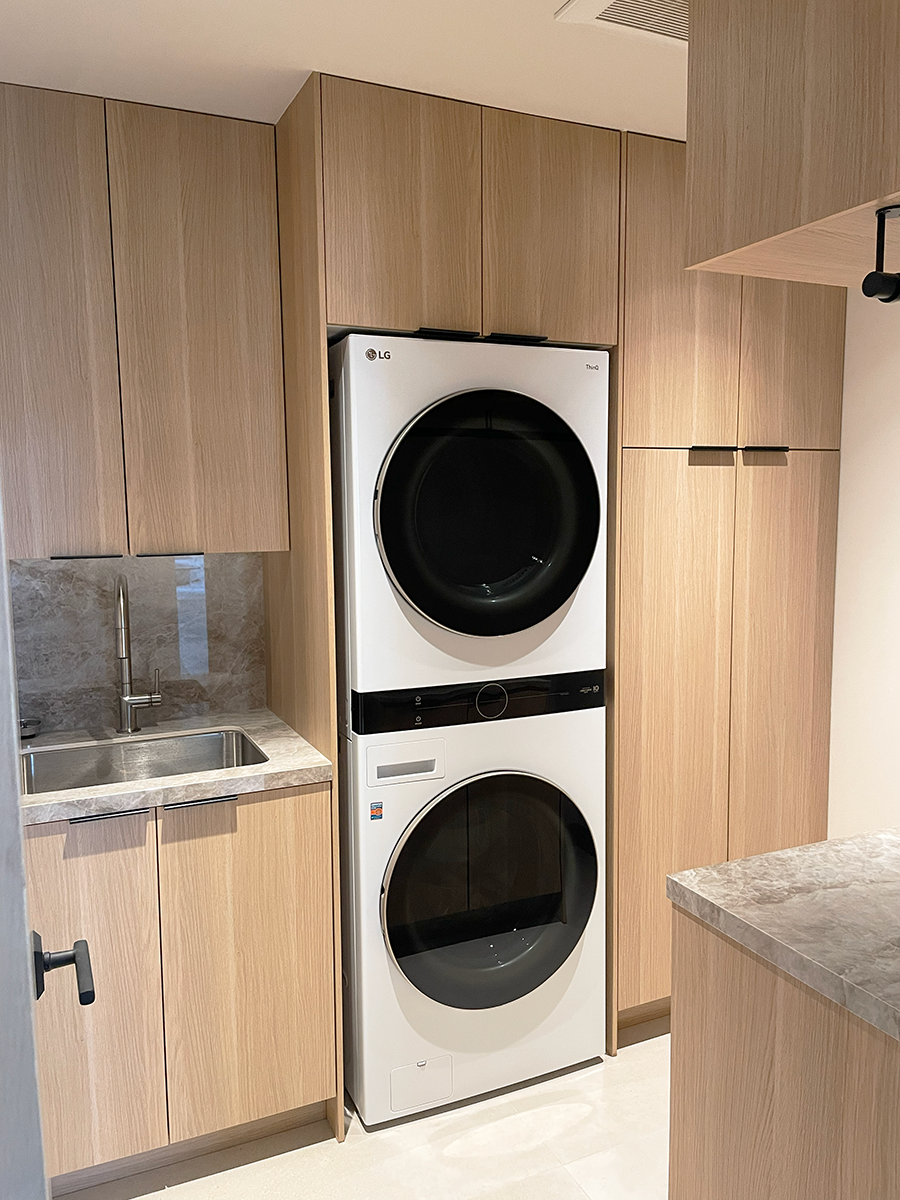 The laundry room blends beauty and function through ample storage, hanging space, and of course a luxurious washer and dryer with great capacity.