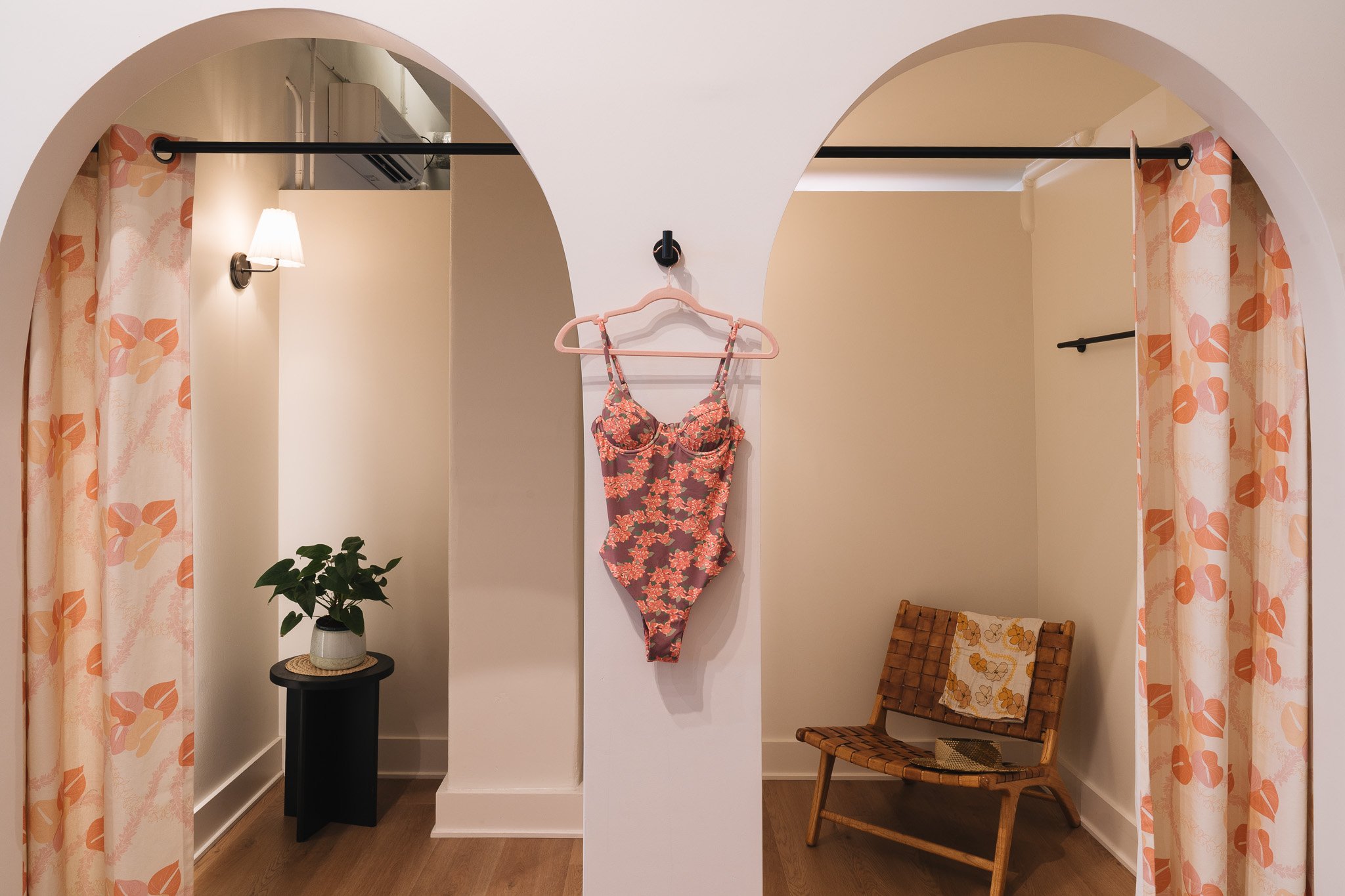 These dressing rooms are framed by arched openings and enclosed by custom branded curtains. This is a perfect opportunity for the company to become a part of the built interior.